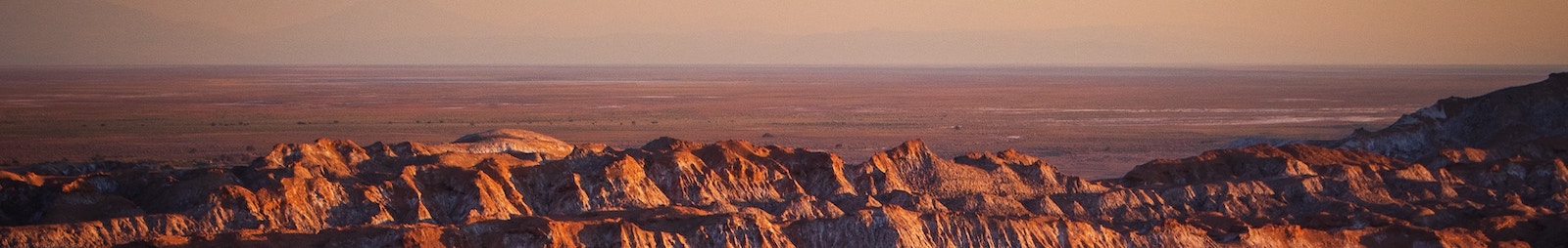 Picture of rocky canoyns and a sky at sunset or morning.