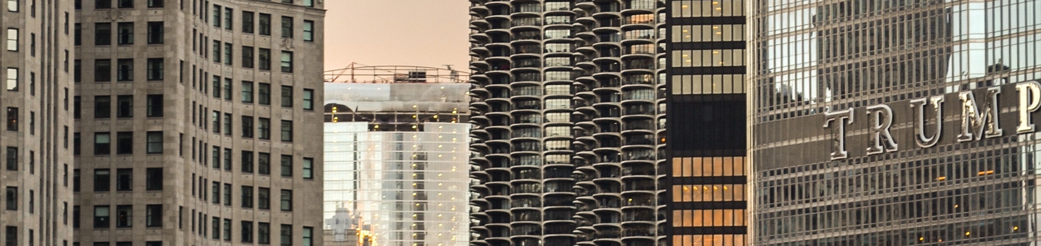 Trump labeled tower next to a bridge with traffic.
